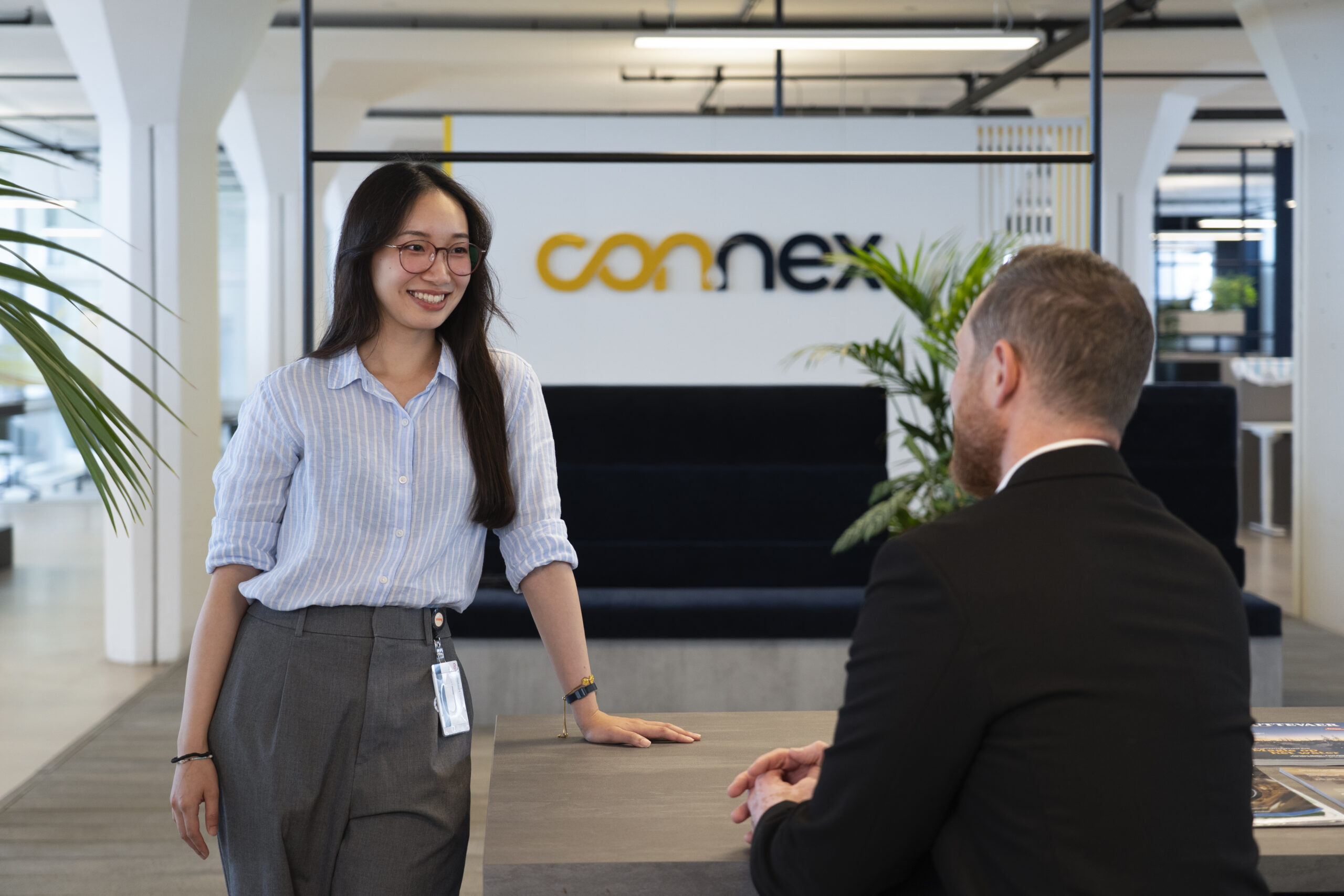 Asian women at a desk with a men.